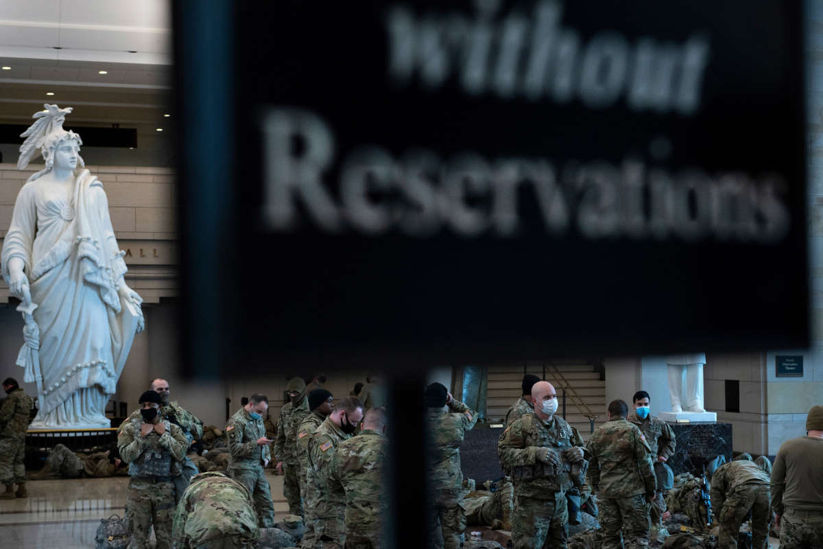 Members of the National Guard rest in the Capitol Visitors Center on Capitol Hill in Washington, D.C., January 13, 2021, ahead of an expected House vote impeaching President Trump.