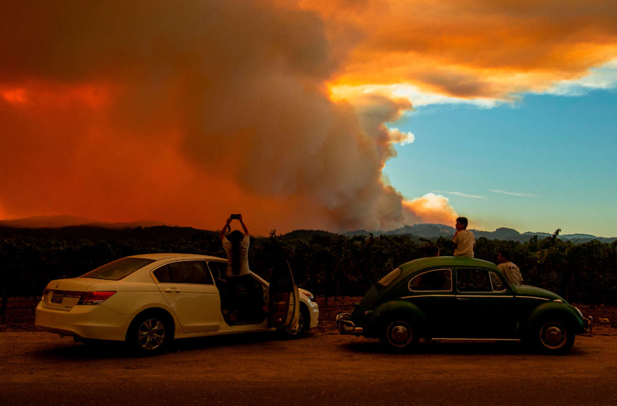 People watch the Walbridge fire, part of the larger LNU Lightning Complex fire, from a vineyard in Healdsburg, California on August 20, 2020.