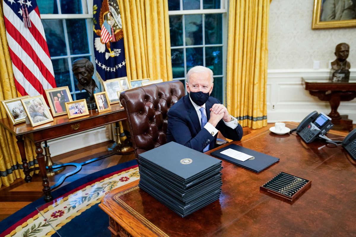 President Joe Biden at his desk in the Oval Office of the White House on January 20, 2021, in Washington, D.C.