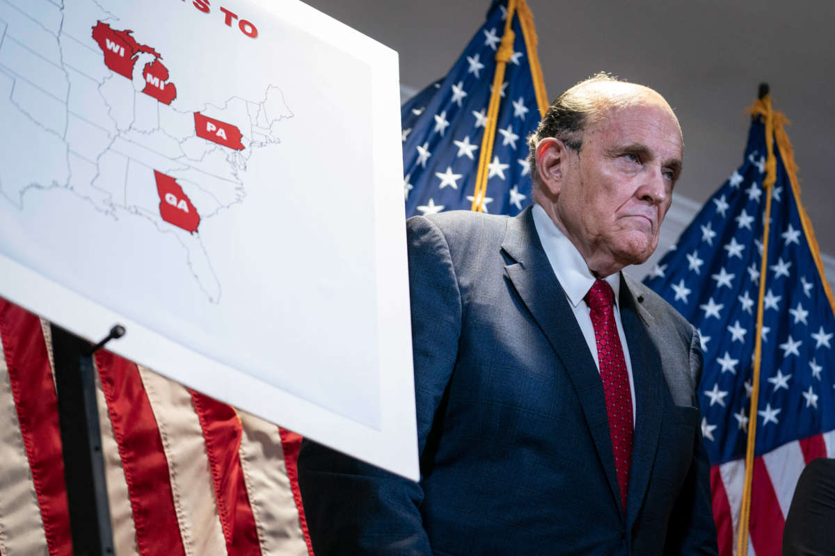 Former New York City Mayor Rudy Giuliani, lawyer for former president Donald Trump, stands next to a map showing the swing states during a news conference about lawsuits related to the presidential election results at the Republican National Committee headquarters in Washington, D.C., on November 19, 2020.