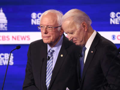 Democratic presidential candidates Sen. Bernie Sanders and former Vice President Joe Biden speak during a break at the Democratic presidential primary debate at the Charleston Gaillard Center on February 25, 2020, in Charleston, South Carolina.