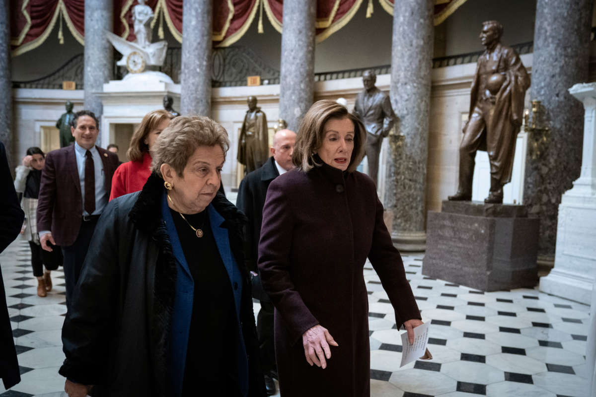 Nancy Pelosi and Donna Shalala walk in the US Capitol building