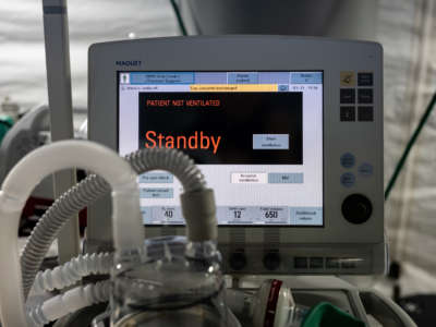 A ventilator screen displays "STANDBY" in orange