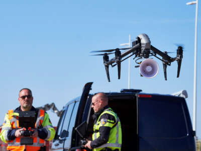 Dutch police officers fly a drone above the seafront of The Hague beach to warn people to keep distance to others amid the COVID-19 pandemic on April 4, 2020, in The Hague, The Netherlands.