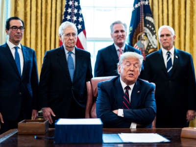 Donald Trump crosses his arms while surrounded by other Donald Trump crosses his armsevill white men
