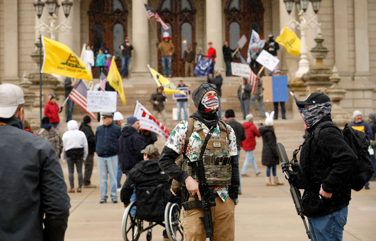 People take part in a protest for "Michiganders Against Excessive Quarantine" at the Michigan State Capitol in Lansing, Michigan, on April 15, 2020.