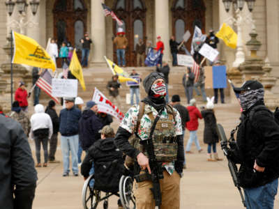 People take part in a protest for "Michiganders Against Excessive Quarantine" at the Michigan State Capitol in Lansing, Michigan, on April 15, 2020.