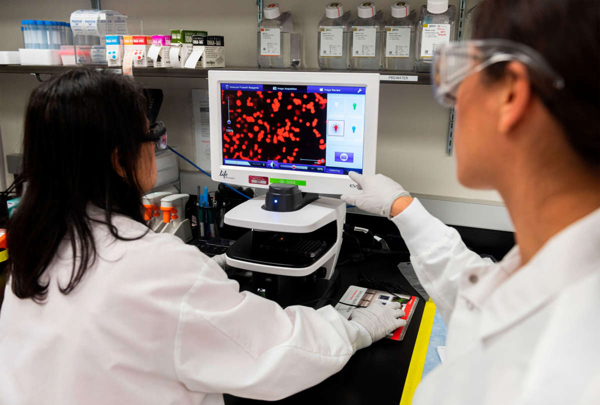 Dr. Sonia Maciejewski, right, and Dr. Nita Patel, director of antibody discovery and vaccine development, look at a sample of a respiratory virus at Novavax labs in Rockville, Maryland, on March 20, 2020, one of the labs developing a vaccine for COVID-19.