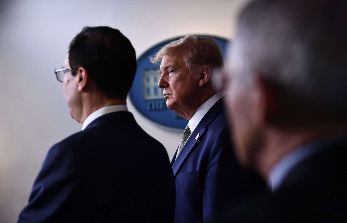 President Trump listens to Treasury Secretary Steven Mnuchin during the daily press briefing on the Coronavirus pandemic situation at the White House on March 17, 2020, in Washington, D.C.