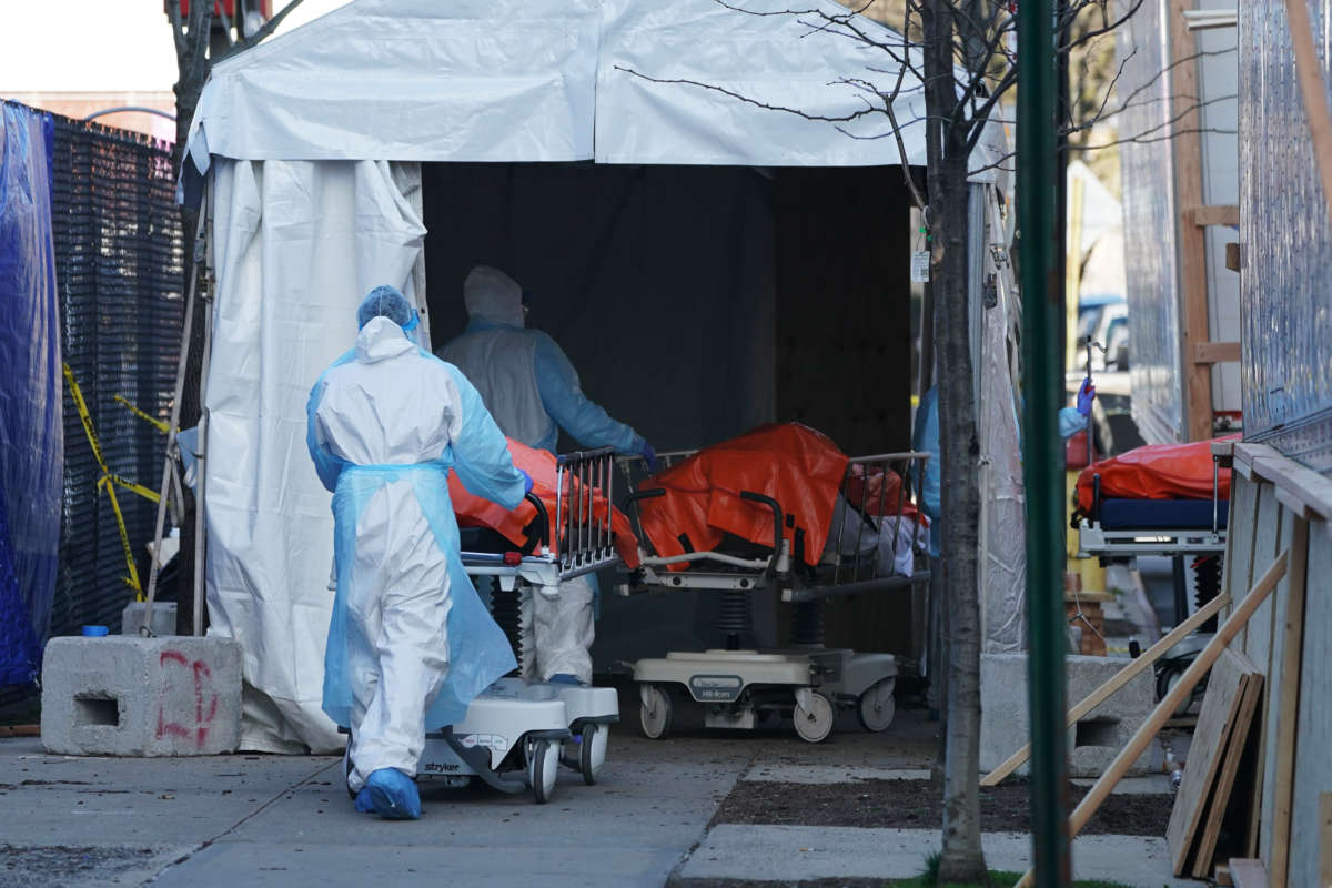 Bodies are moved to a refrigerator truck serving as a temporary morgue outside of Wyckoff Hospital in the Borough of Brooklyn on April 4, 2020, in New York.