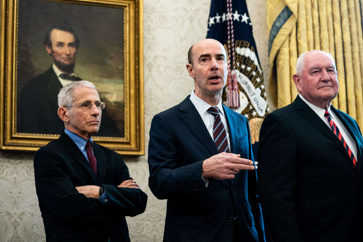 National Institute of Allergy and Infectious Diseases Director Anthony Fauci, Secretary of Labor Eugene Scalia and Agriculture Secretary Sonny Perdue attend a bill signing ceremony for H.R. 748, the CARES Act in the Oval Office of the White House on March 27, 2020, in Washington, D.C.