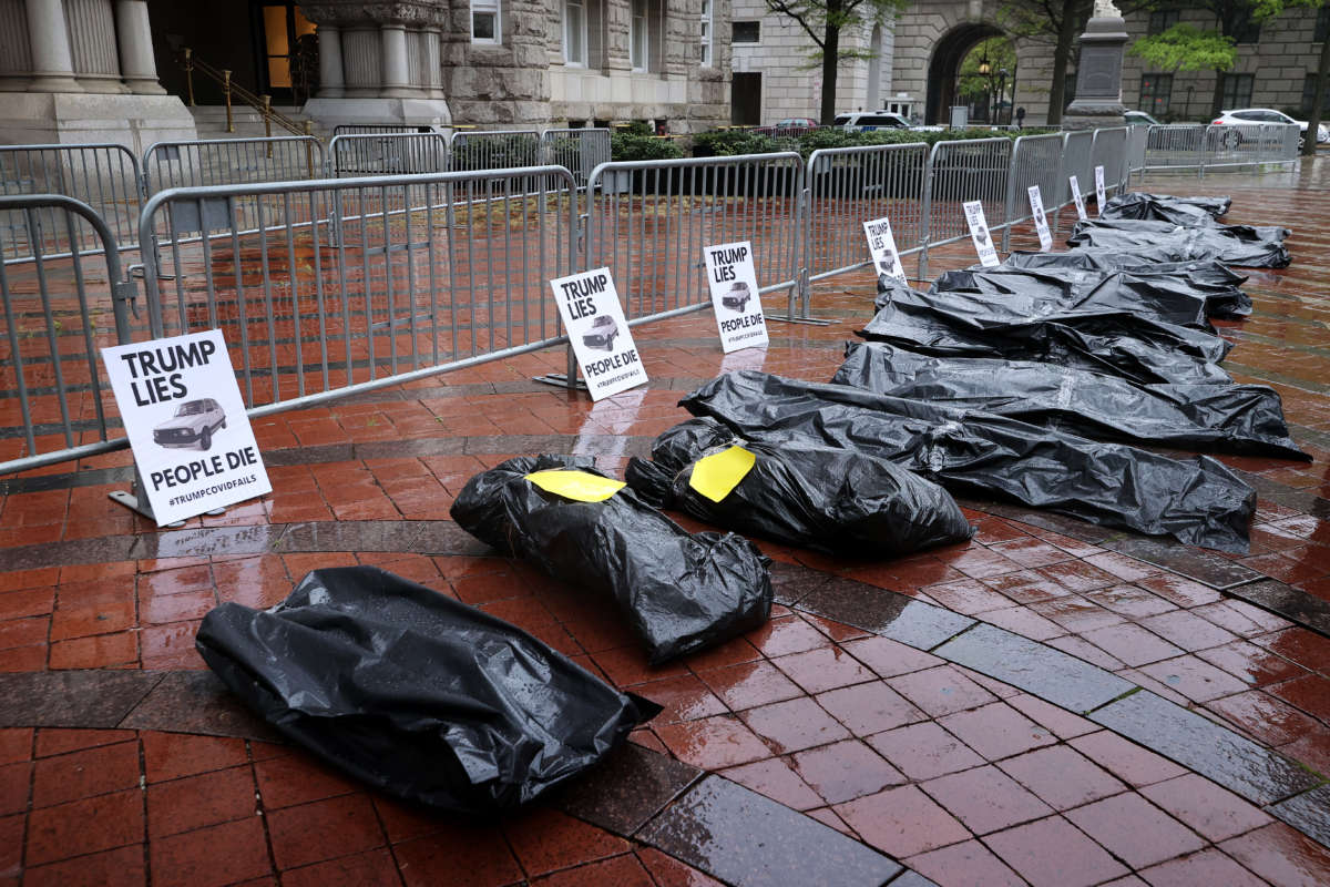 Mock body bags are lined up in front of the Trump International Hotel, set down by people demonstrating against President Donald Trump's response to the novel coronavirus pandemic now sweeping the United States April 23, 2020, in Washington, D.C.