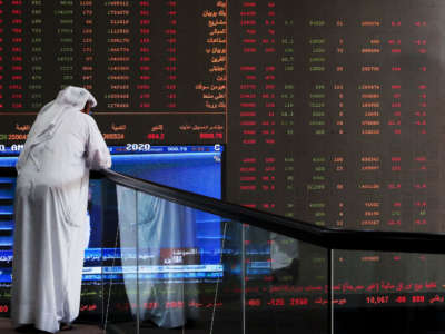 A Kuwaiti trader checks stock prices at Boursa Kuwait in Kuwait City, on March 8, 2020.
