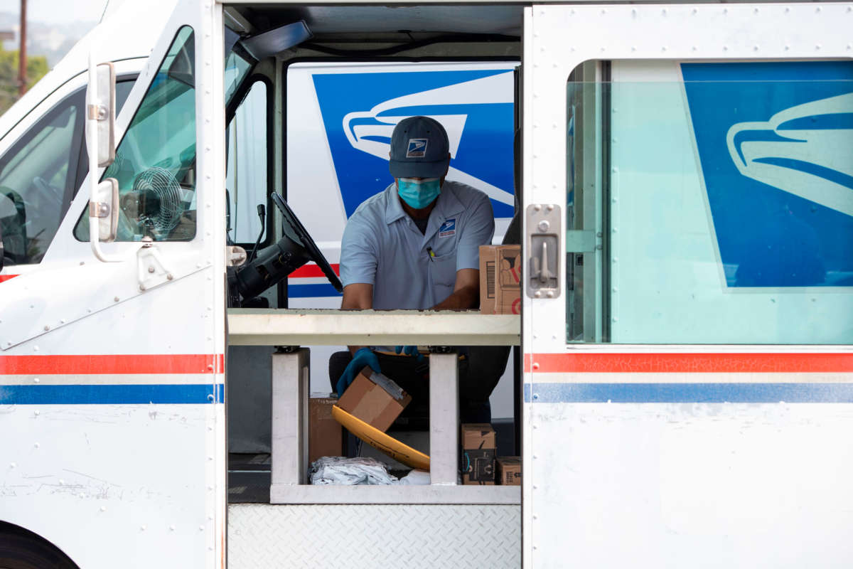 Mail carrier Oscar Osorio continues to deliver mail amid the COVID-19 pandemic, on April 29, 2020, in Los Angeles, California.