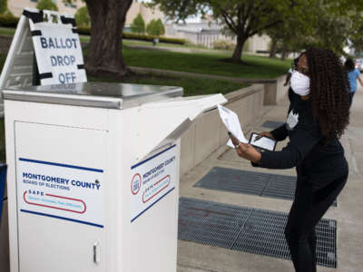 An Ohio voter drops off her ballot at the Board of Elections in Dayton, Ohio, on April 28, 2020.