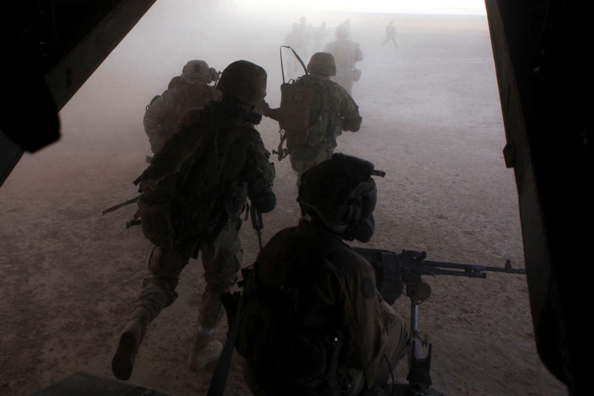 U.S. Marines and Georgian soldiers exit a Marine Corps MV-22 Osprey during an operation in Helmand province, Afghanistan, on September 23, 2013.