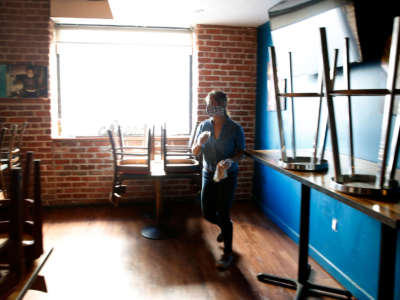 Deanna Sison walks through the temporarily shuttered Victory Hall and Parlor bar where her Little Skillet restaurant is based in San Francisco, California, on April 28, 2020. Sison is struggling to keep her restaurants after federal funds made available to assist small business owners during the coronavirus pandemic quickly dried up.
