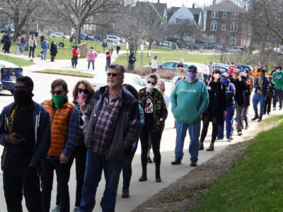 Voters wait in line at a polling place at Riverside University High School on April 7, 2020, in Milwaukee, Wisconsin.