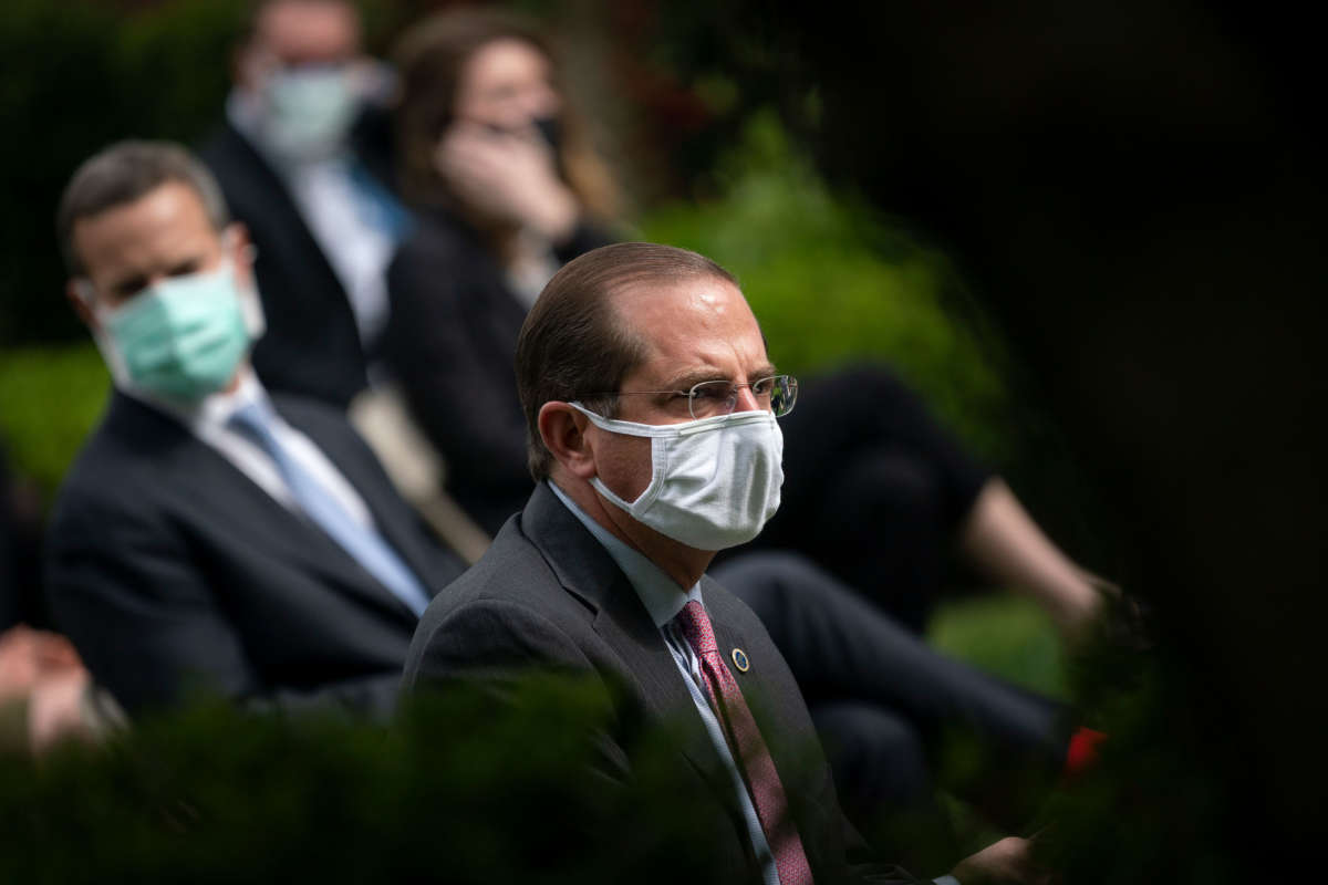 Secretary of Health and Human Services Alex Azar and others wear face masks while attending a press briefing about coronavirus testing in the Rose Garden of the White House on May 11, 2020, in Washington, D.C.