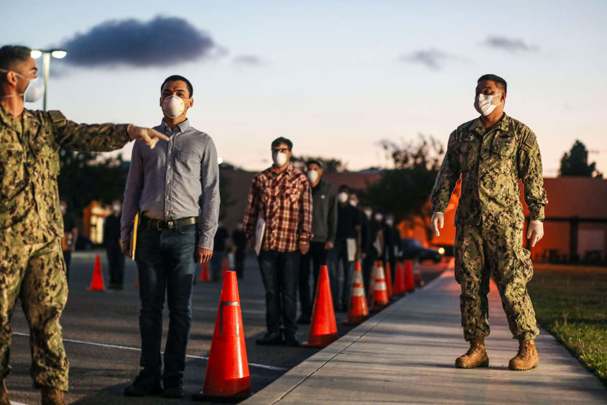 U.S. Marine recruits stand in formation as they wait in line for health screenings at the Marine Corps Recruit Depot on April 13, 2020, in San Diego, California.