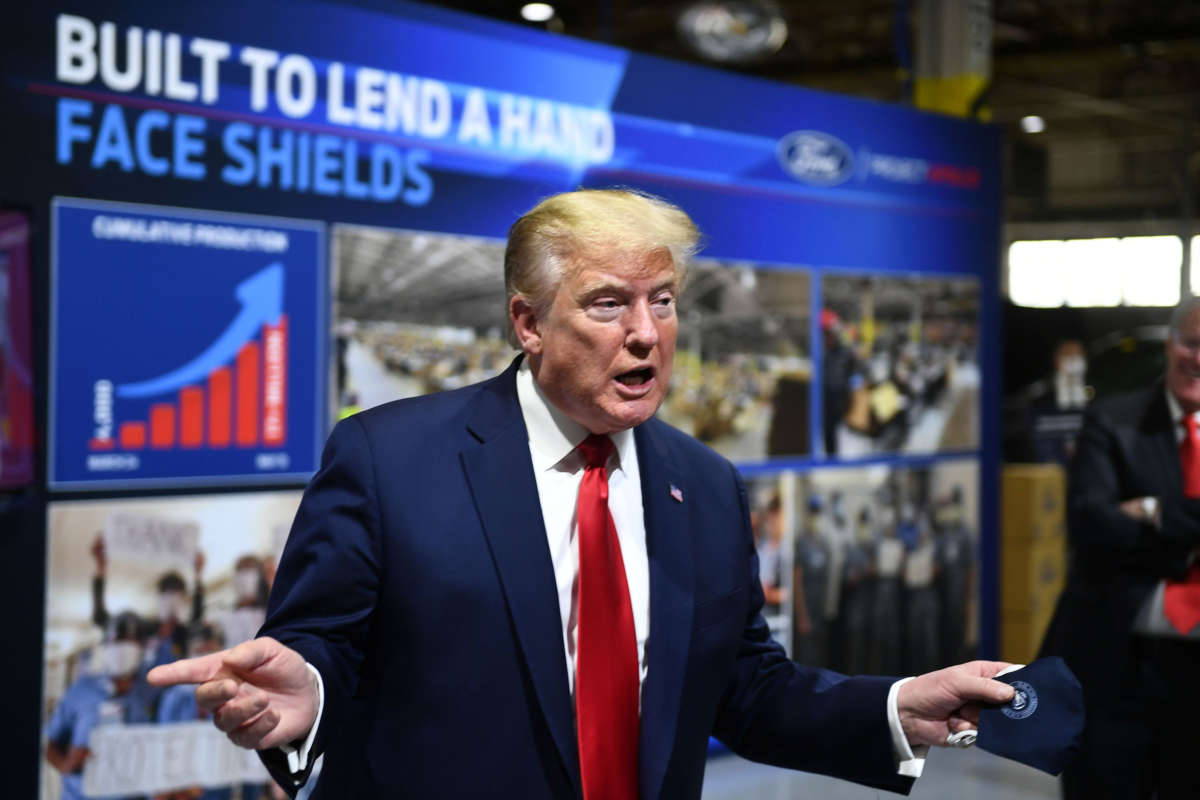President Trump holds a mask as he speaks during a tour of the Ford Rawsonville Plant in Ypsilanti, Michigan, on May 21, 2020.