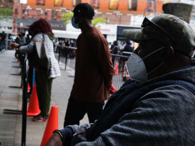 Over one thousand individuals wait in line at the Barclays Center in Brooklyn for a free food distribution on May 15, 2020, in New York City.