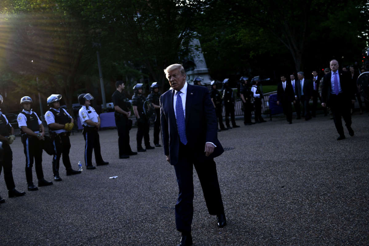 President Trump walks back to the White House escorted by the Secret Service after appearing outside of St John's Episcopal church across Lafayette Park in Washington, D.C. on June 1, 2020.