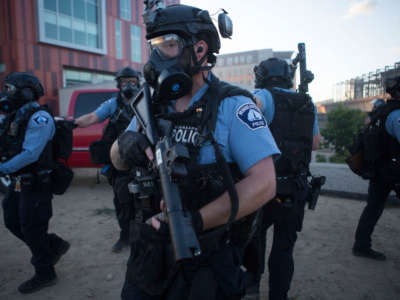 Police officers clear the area of protesters after curfew in Minneapolis, Minnesota, on May 29, 2020.