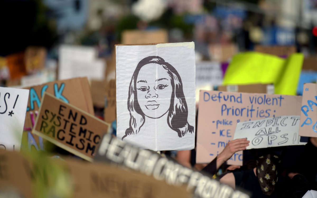 Protesters march holding placards and a portrait of Breonna Taylor during a demonstration against racism and police brutality, in Hollywood, California, on June 7, 2020.