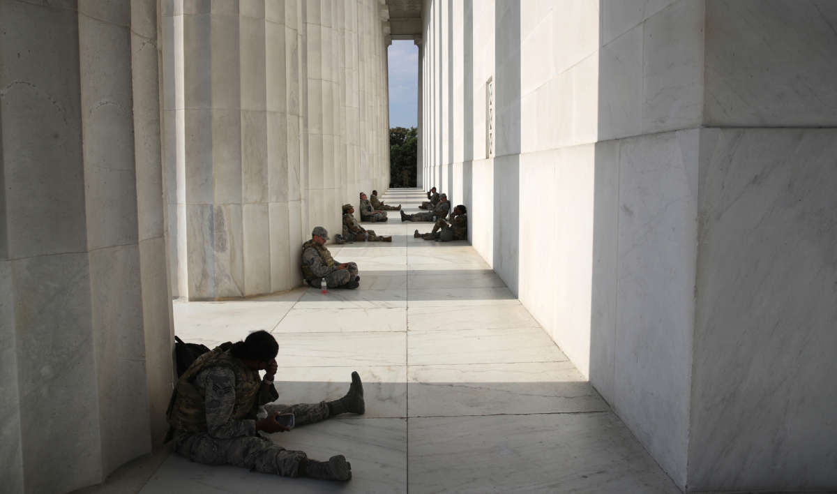Members of the D.C. National Guard take advantage of the shade at the Lincoln Memorial as demonstrators citywide protest against police brutality and the death of George Floyd, on June 3, 2020, in Washington, D.C.