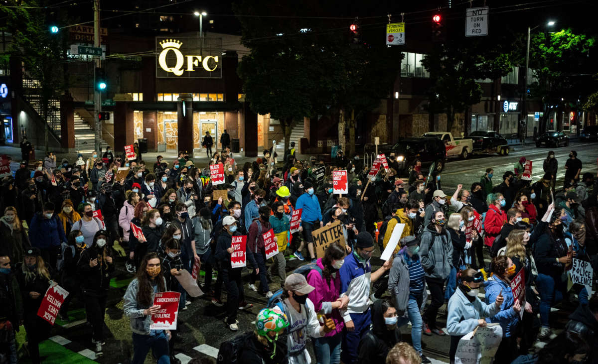 Demonstrators march to the Seattle Police Department's East Precinct after marching inside Seattle City Hall, led by Seattle City Council member Kshama Sawant, on June 9, 2020, in Seattle, Washington.