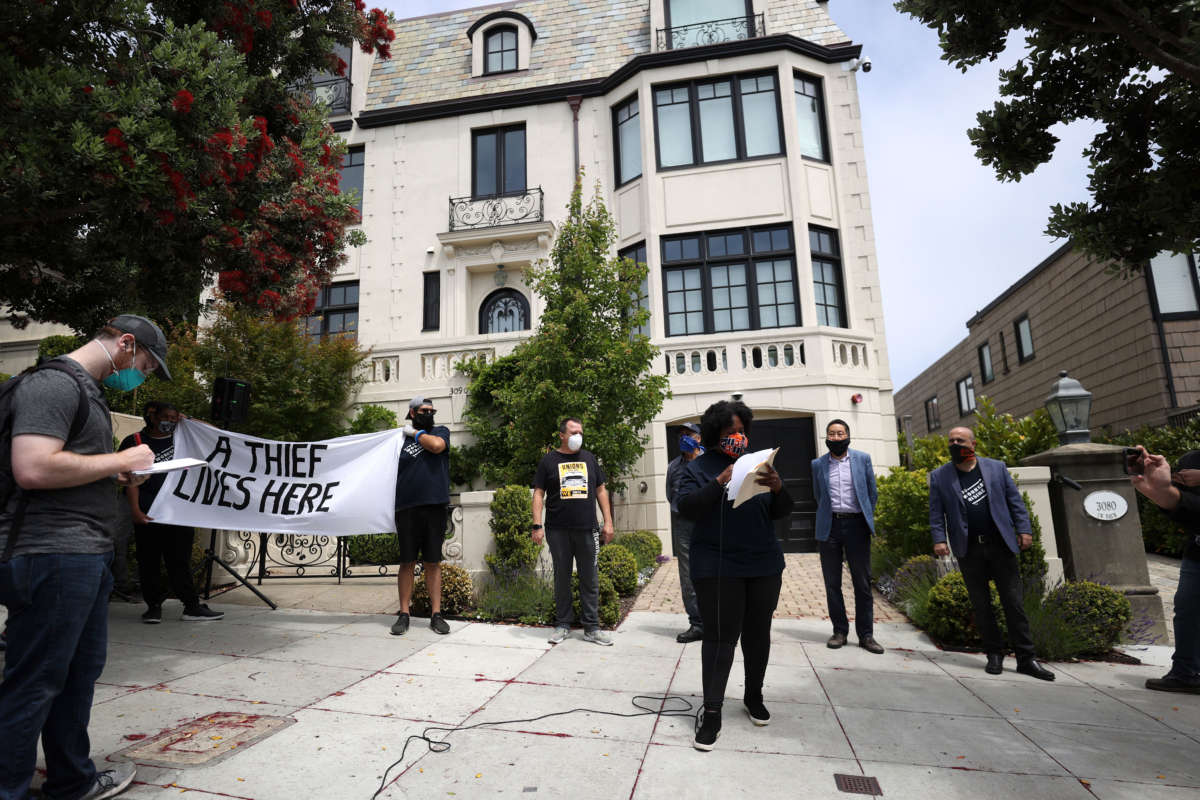 Protesters stage a demonstration in front of the home of Uber CEO Dara Khosrowshahi on June 24, 2020, in San Francisco, California.