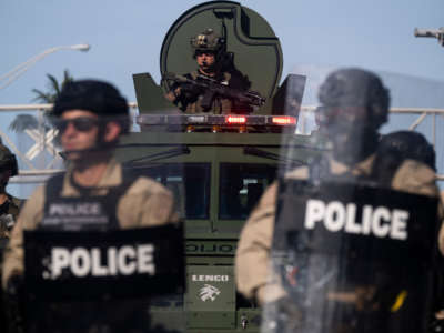 A Miami Police officer watches protestors from an armored vehicle during a rally in response to the death of George Floyd in Miami, Florida, on May 31, 2020.