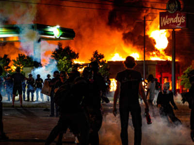 A restaurant burns during a protest after an Atlanta police officer shot and killed Rayshard Brooks, 27, at a Wendy's fast food restaurant drive-thru Friday night in Atlanta, Georgia, on June 13, 2020.