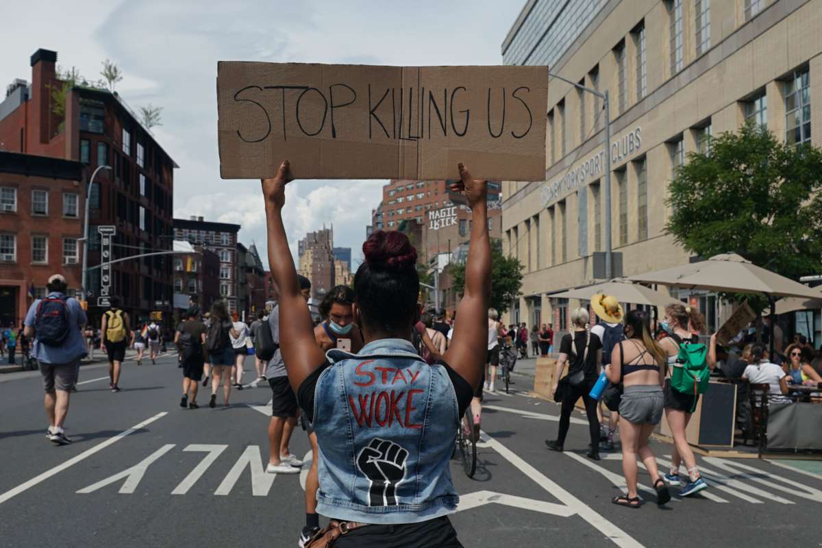 Protesters hold signs during the Queer Liberation March hosted by The Reclaim Pride Coalition for Trans and Queer Black Lives and Against Police Brutality in lower Manhattan on June 28, 2020, in New York.