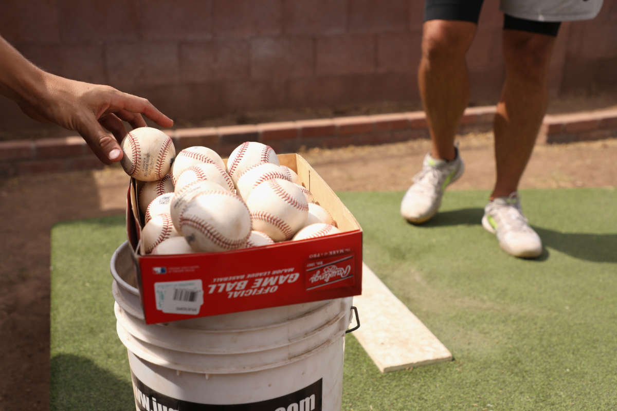 Baseballs are taken from a box as MLB pitchers practice in a backyard throwing session on June 5, 2020, in Scottsdale, Arizona.