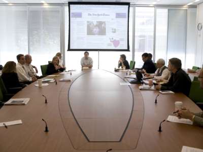 White journalists meet in the Page One conference room near the newsroom at the New York Times Building in May 2008, in New York City.