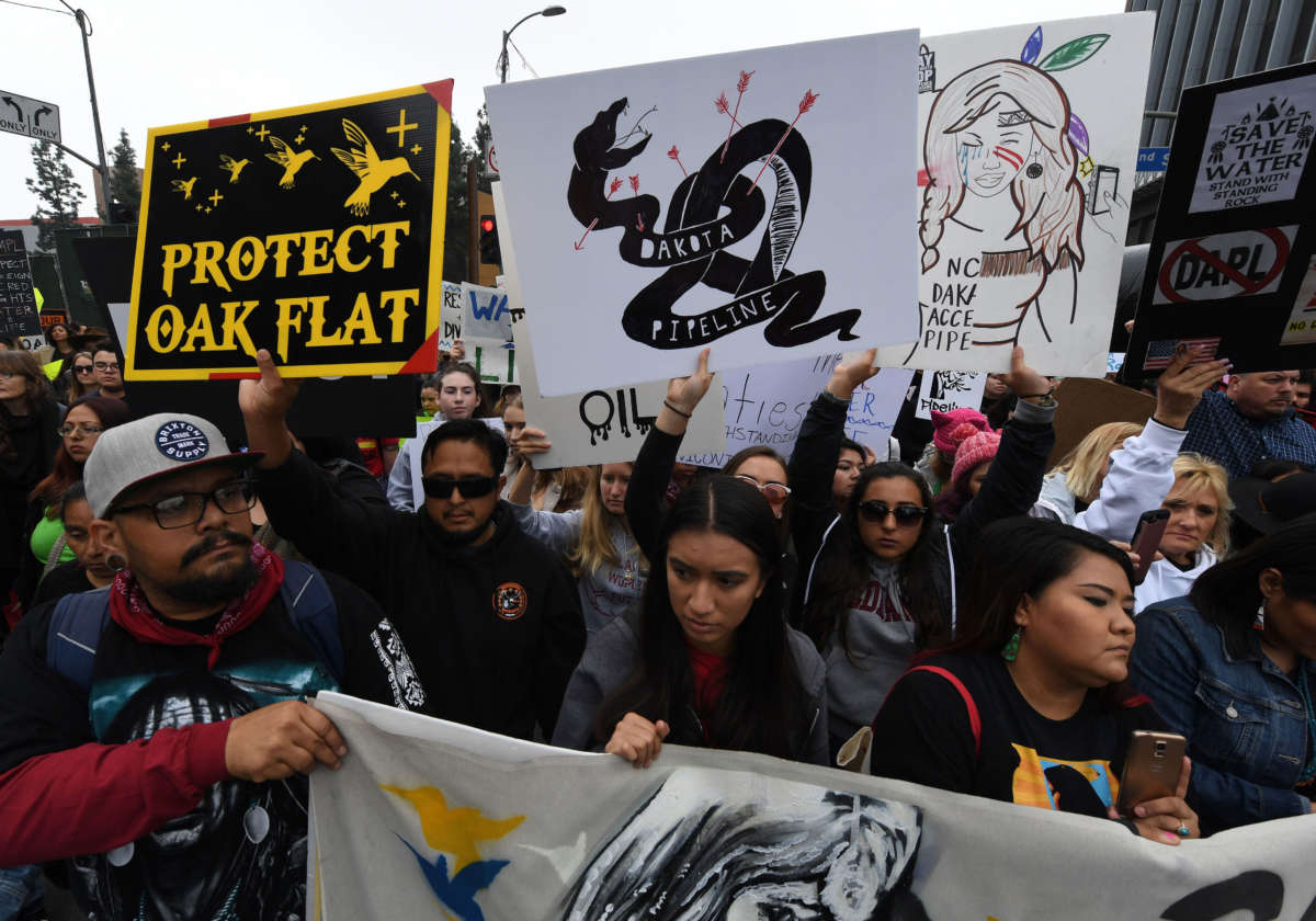 Demonstrators march to the Federal Building in protest against President Trump's executive order fast-tracking the Keystone XL and Dakota Access oil pipelines, in Los Angeles, California, on February 5, 2017.