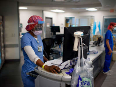 Registered Respiratory Therapist Niticia Mpanga looks through patient information in the ICU at Oakbend Medical Center in Richmond, Texas, on July 15, 2020.