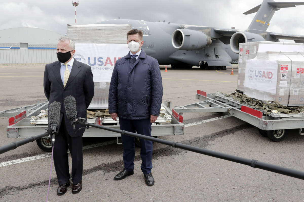 U.S. Ambassador to Russia John J. Sullivan (left) and Dmitry Nikitenko, first deputy general director of the Pirogov National Medical and Surgical Center, stand by a batch of medical ventilators unloaded from a military transport aircraft at Vnukovo-3 Airport.