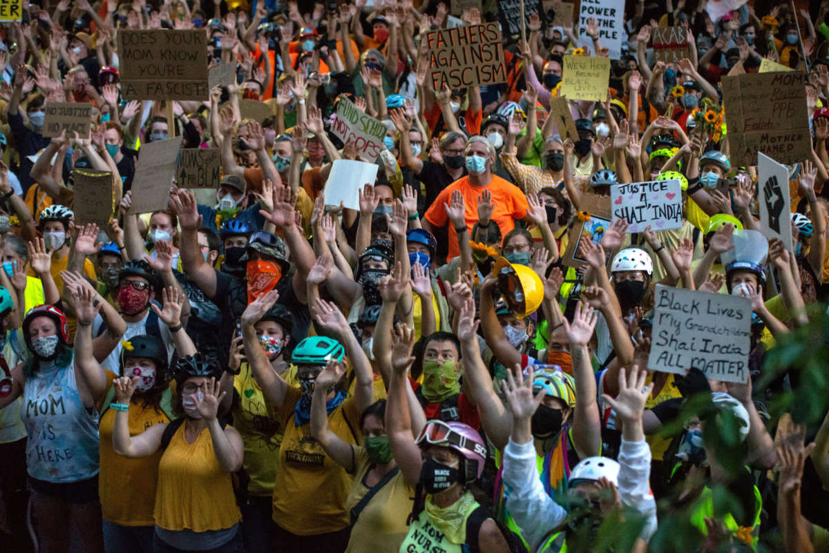 Protesters hold their hands in the air during a Black Lives Matter protest in front of the Multnomah County Justice Center on July 20, 2020, in Portland, Oregon.
