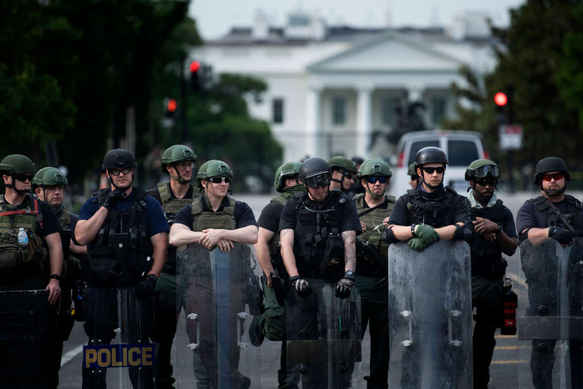 Members of the Federal Bureau of Prisons and other law enforcement block a street near the White House as protests over the death of George Floyd continue, June 3, 2020, in Washington, D.C.