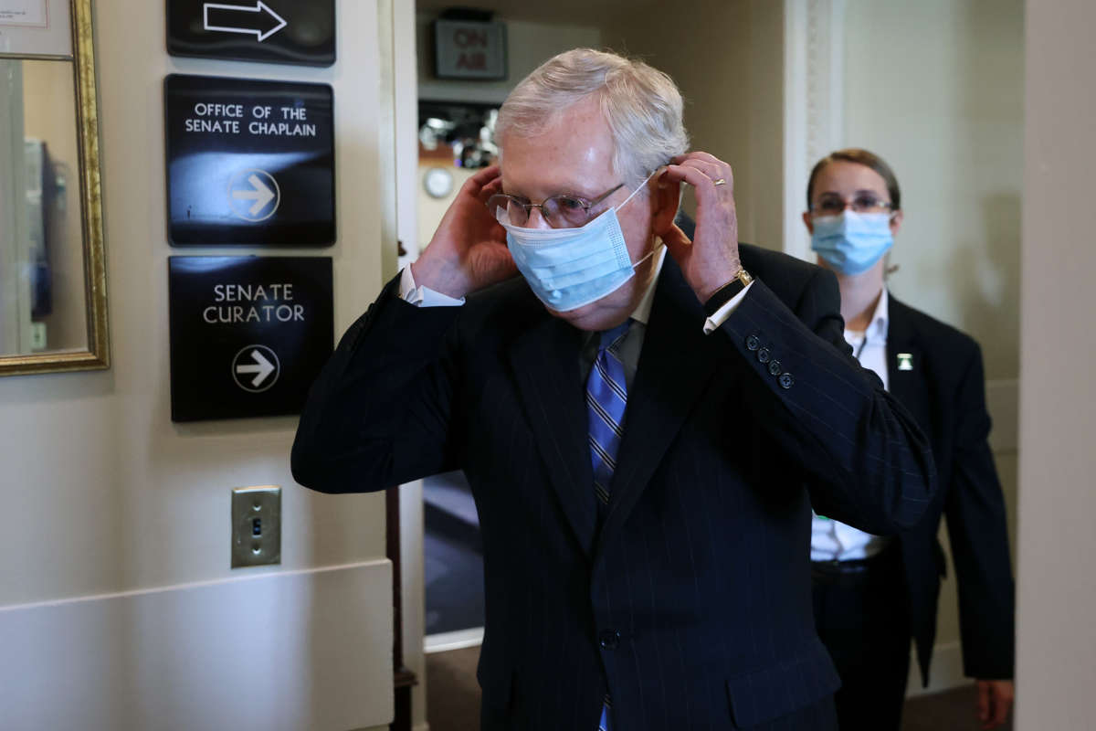 Senate Majority Leader Mitch McConnell replaces his face mask as he leaves a news conference at the U.S. Capitol, on June 17, 2020, in Washington, D.C.
