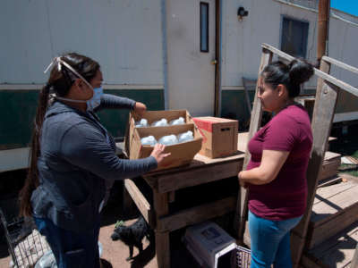 Water is delivered by staff of the John Hopkins Center for American Indian Health at a home with no running water, near the Navajo Nation town of Fort Defiance in Arizona on May 22, 2020.