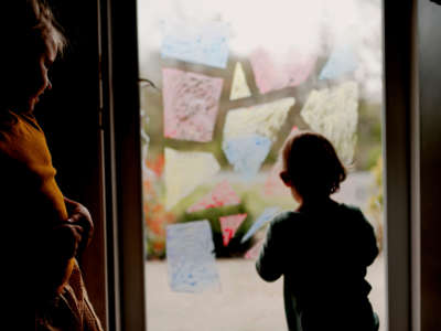 Family, children painting on glass door