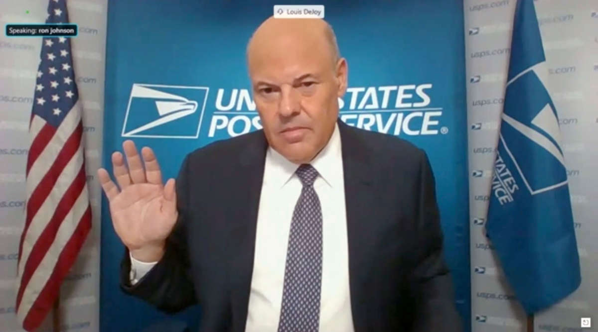 In this screenshot from U.S. Senate's livestream, U.S. Postal Service Postmaster General Louis DeJoy is sworn in for a virtual Senate Homeland Security and Governmental Affairs Committee hearing on U.S. Postal Service operations during the COVID-19 pandemic, August 21, 2020, in Washington, D.C.