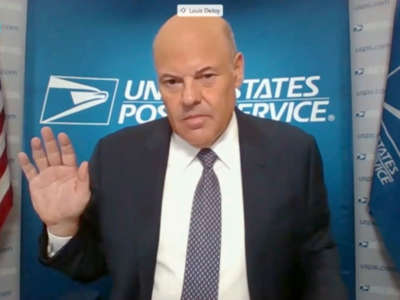 In this screenshot from U.S. Senate's livestream, U.S. Postal Service Postmaster General Louis DeJoy is sworn in for a virtual Senate Homeland Security and Governmental Affairs Committee hearing on U.S. Postal Service operations during the COVID-19 pandemic, August 21, 2020, in Washington, D.C.