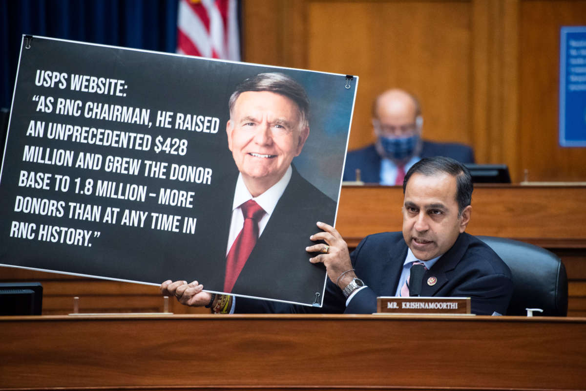 Representative Raja Krishnamoorthi holds a picture referencing Robert Duncan, chairman of the USPS Service Board of Governors, during a hearing before the House Oversight and Reform Committee on August 24, 2020, on Capitol Hill in Washington, D.C.