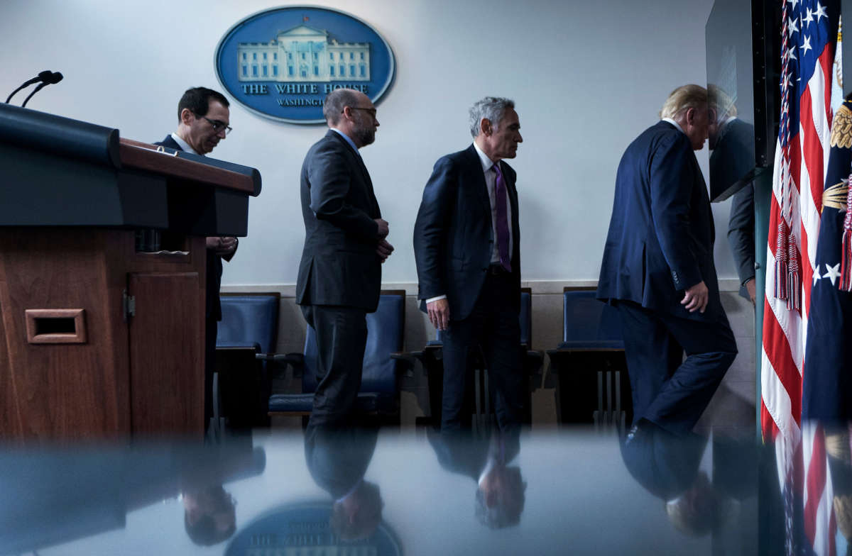 From left, Secretary of the Treasury Steven Mnuchin, Director of the Office of Management and Budget Russell Vought, member of the coronavirus task force Scott Atlas, and President Trump leave after a briefing at the White House August 10, 2020, in Washington, D.C.