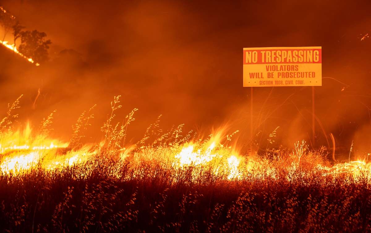 Flames race through a field in Winters, California, on August 19, 2020.